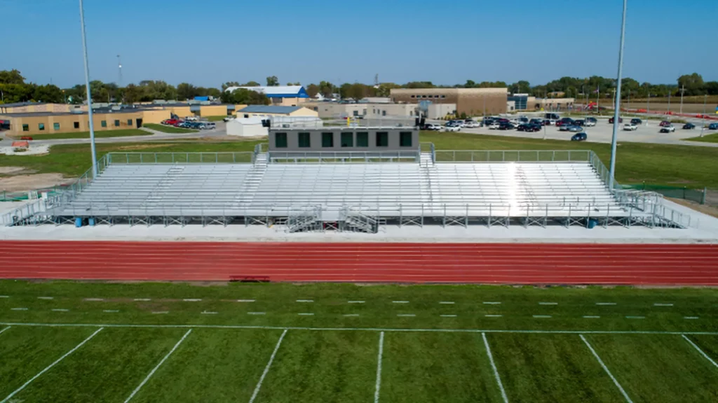 Outdoor elevated bleachers along the side of a running track.