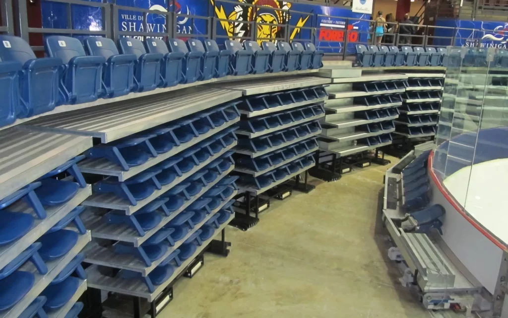 Stacked and stored, blue arena indoor bleacher seats.